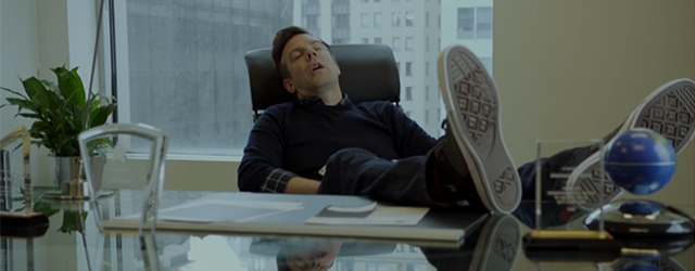 a man asleep at his desk while in the office